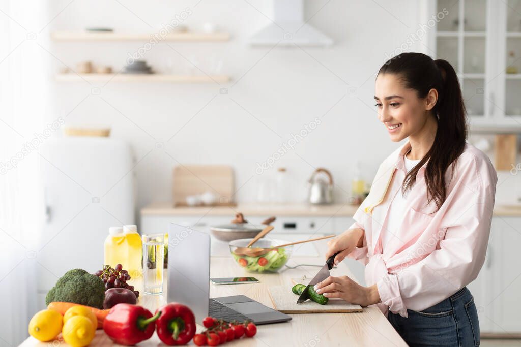 Nutrition educator reading articles on a laptop